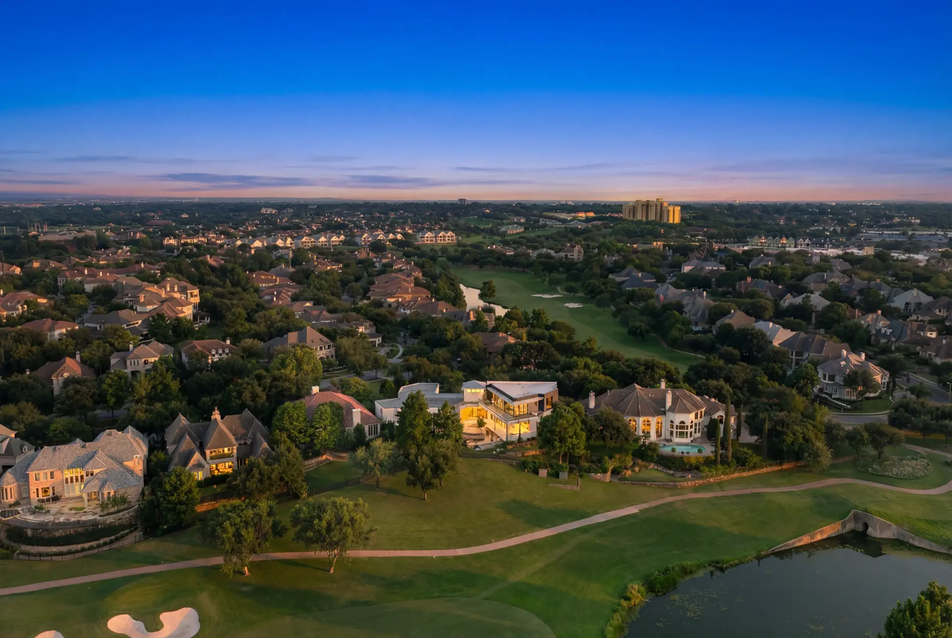 Twilight aerial real estate photography of luxury Dallas golf-course community by F2 Visuals